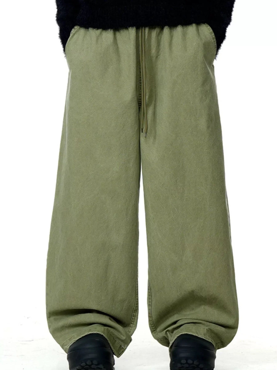 Army green relaxed wide-leg drawstring trousers with pockets and a comfortable fit.