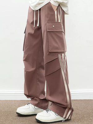 Oversized cargo pants in dusty pink with flap pockets and side stripe detail.