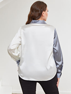 Satin split-tone button-down blouse in light blue and white, with long sleeves.