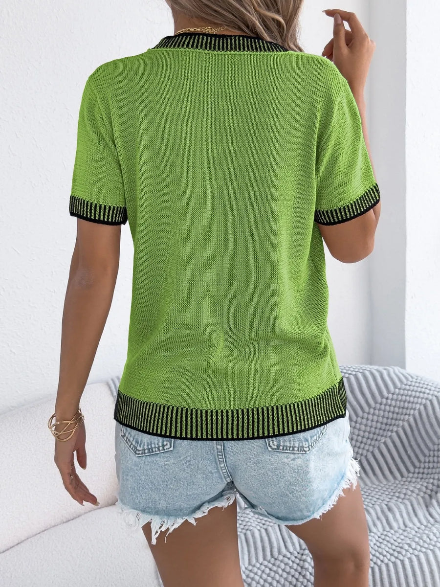 Green knit tee with contrast trim on collar, sleeves, and hem.
