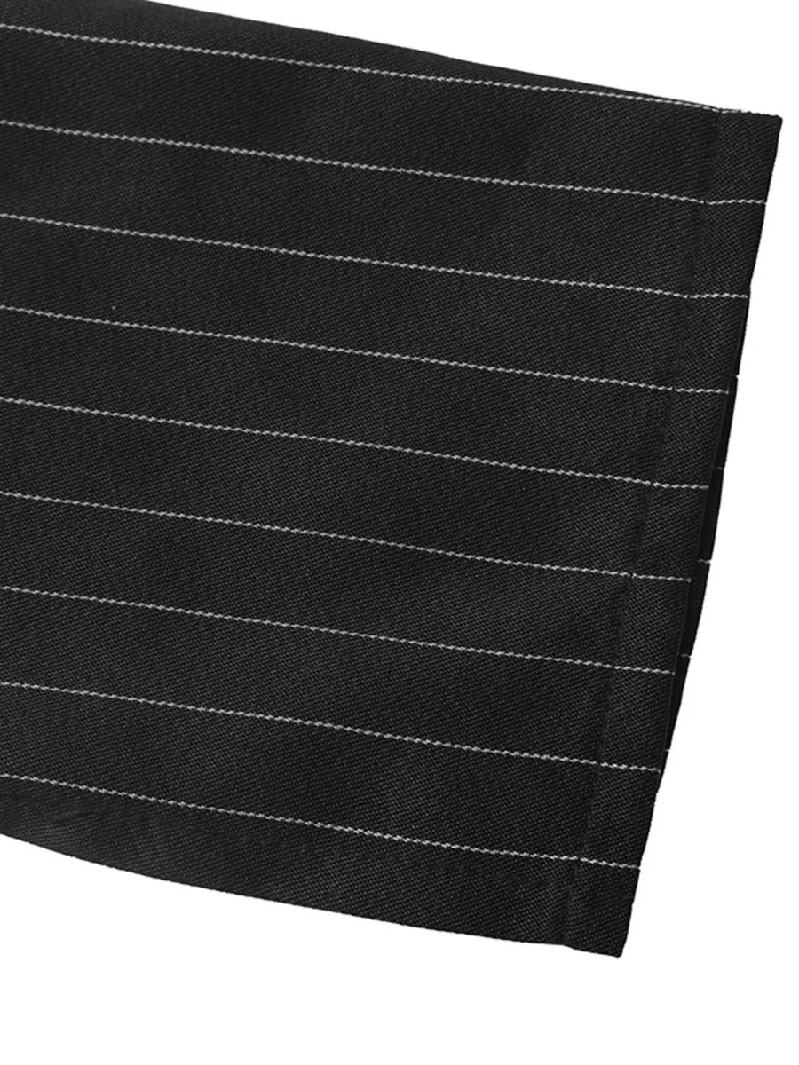 peplum top in black with decorative button and hip-length