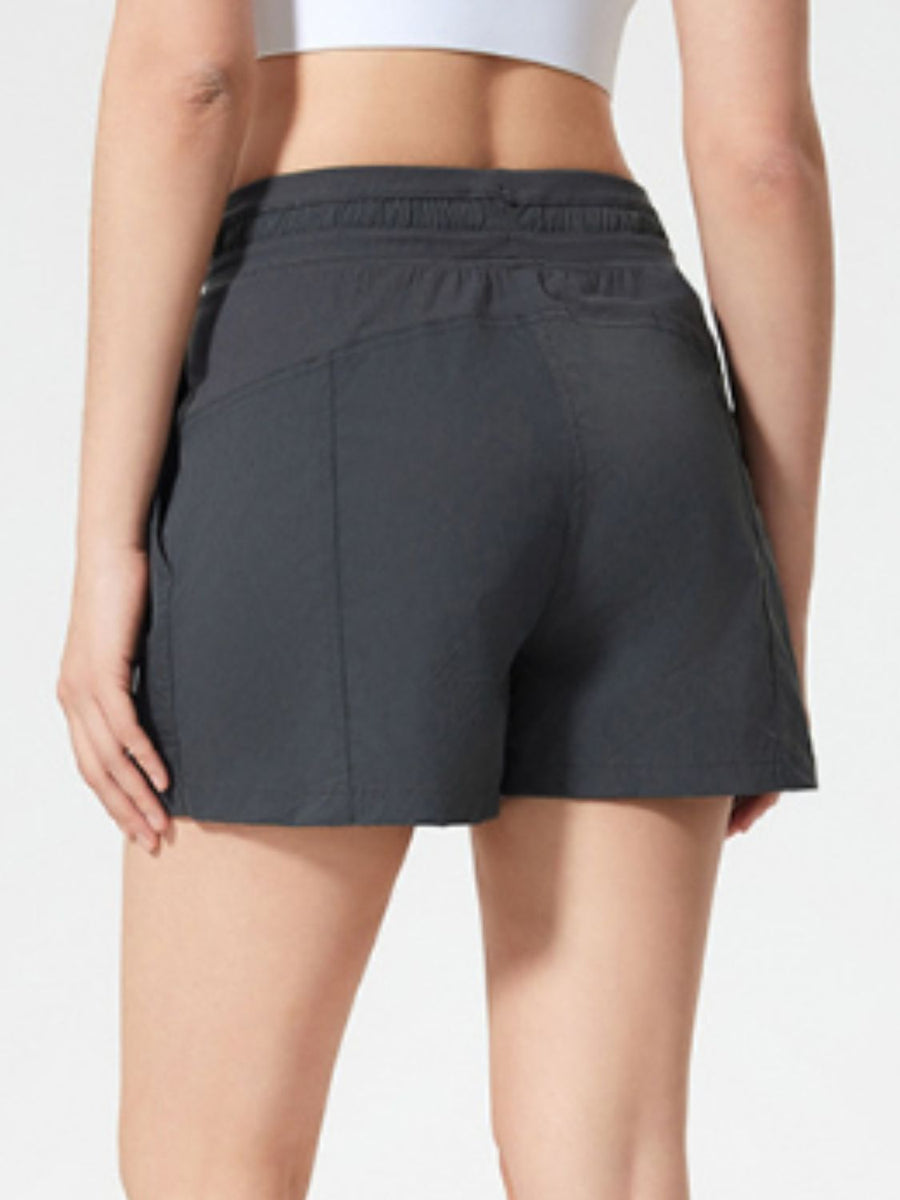 Coastal drawstring utility shorts in dark gray with side pockets and elastic waistband.