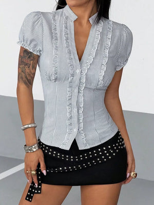 light blue blouse featuring buttoned and striped