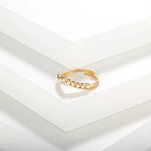 Gold adjustable ring with a row of small pearls.