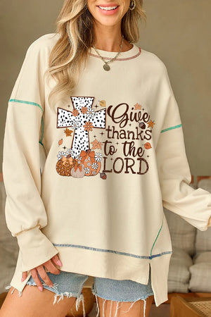 Beige graphic cross sweatshirt with pumpkins, leaves, and "Give thanks to the Lord" text.