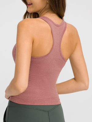 Dusty pink ribbed racerback tank top with a seamless texture.