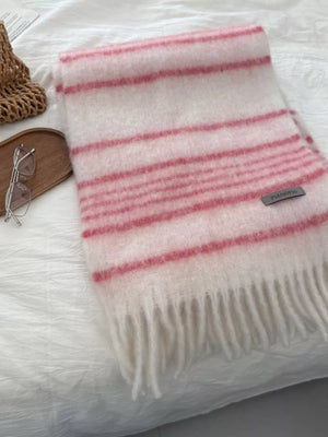 Pink and white striped fringe scarf with a soft texture.