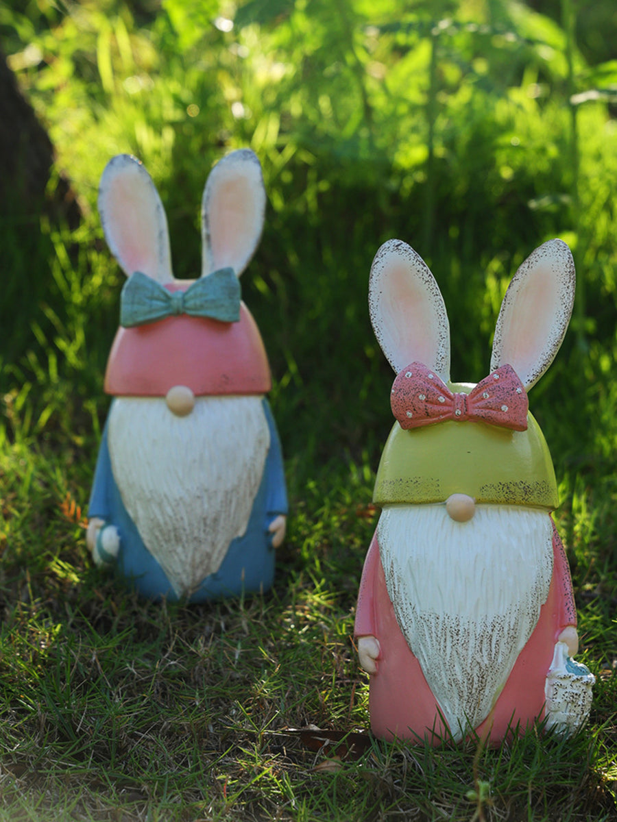 Easter Bunny gnome figures in pastel blue and blush pink with bunny ears and bows.