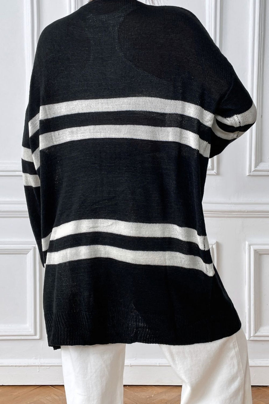 Black and white striped oversized knit cardigan with a relaxed fit.