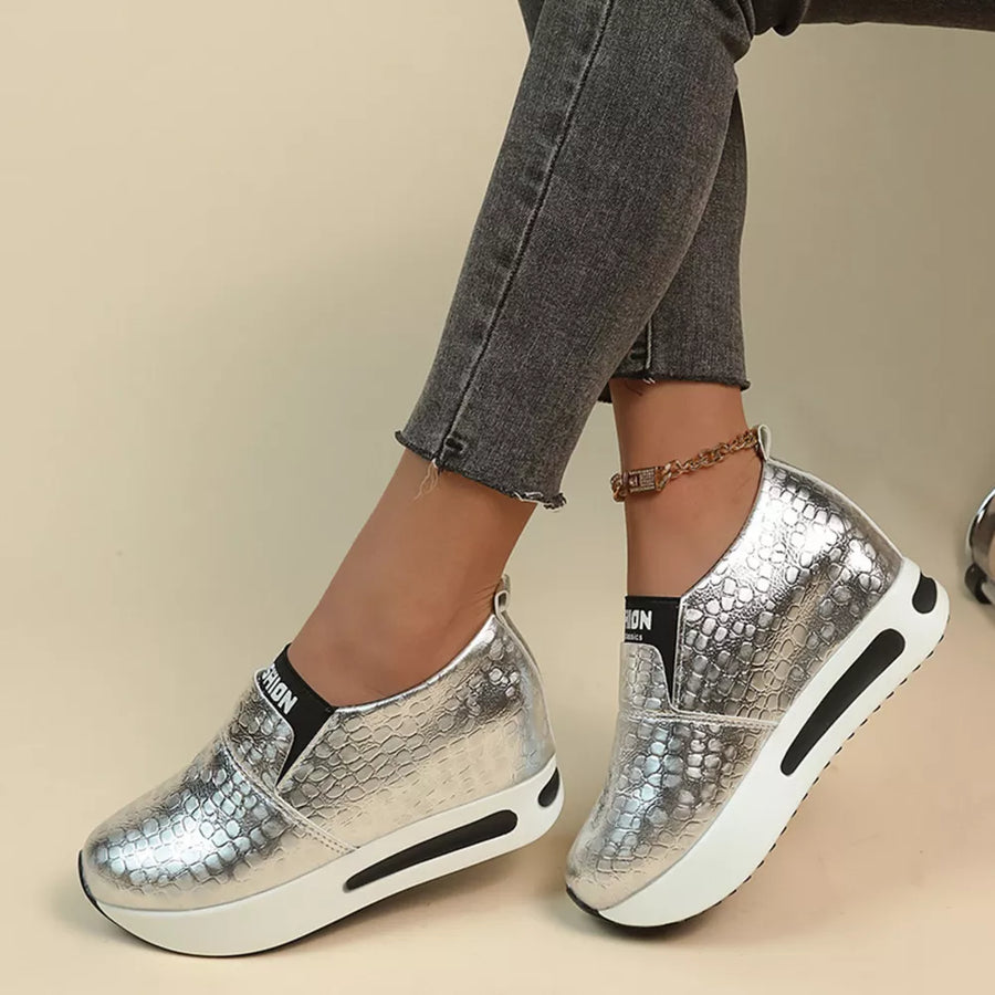 Silver metallic crocodile-embossed platform sneakers with chunky sole detail.