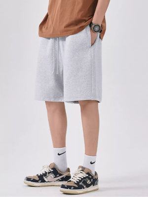 Light gray chino shorts with drawstring waist and relaxed fit.