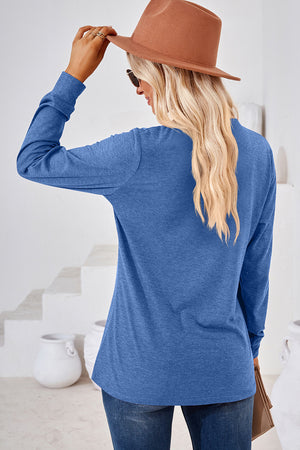 Blue Henley button-down knit top with long sleeves and a relaxed fit.