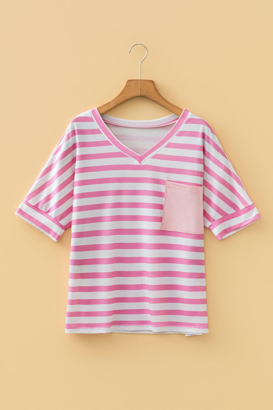 Striped v-neck t-shirt in blush pink with a chest pocket and short sleeves.