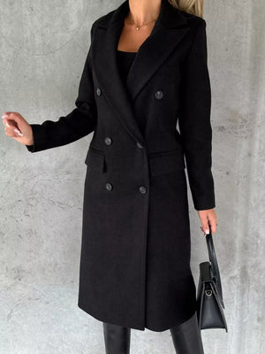 Black double-breasted longline trench coat with button details and notched lapels.