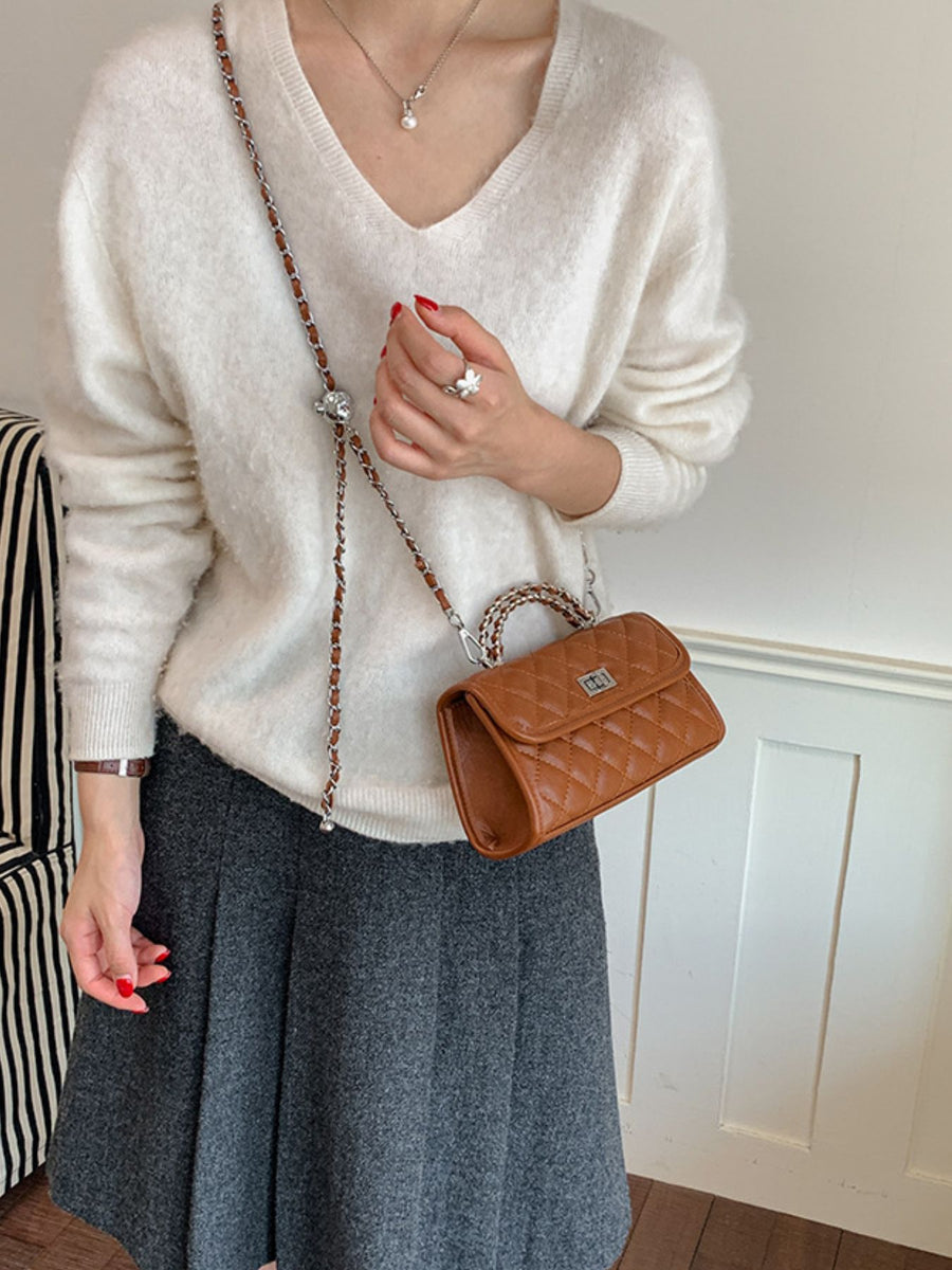 Black crossbody bag featuring quilted and quilted