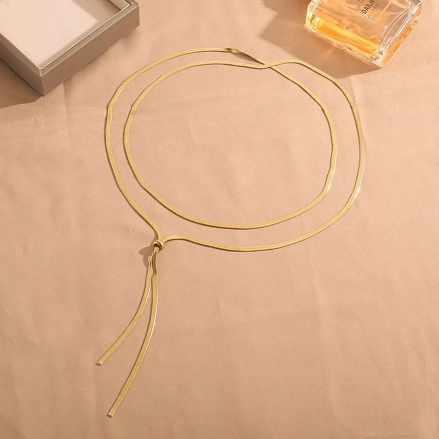 Gold layered snake chain necklace with a knot and dangling ends.