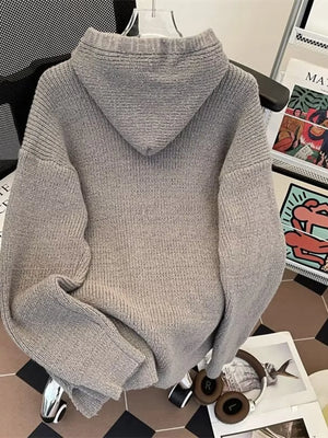Gray knit hoodie with ribbed texture and relaxed fit