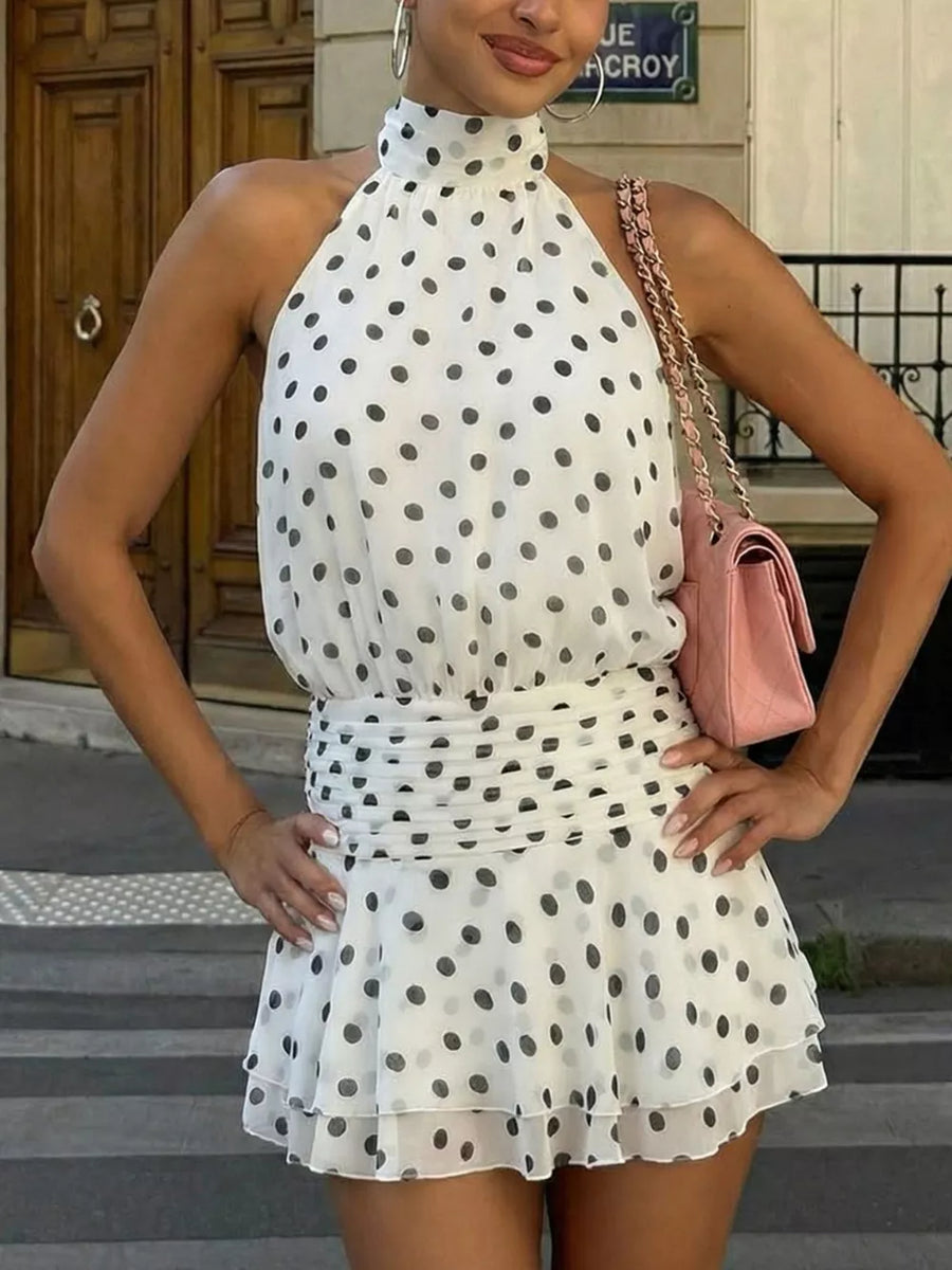 White polka dot halter neck mini dress with ruched waist and ruffled hem.