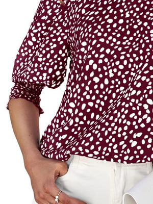 Burgundy animal print half sleeve blouse with ruched cuffs.