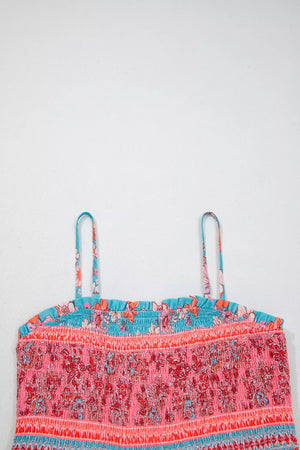 Smocked floral maxi dress with spaghetti straps and a ruffled neckline in pink, orange, and blue.