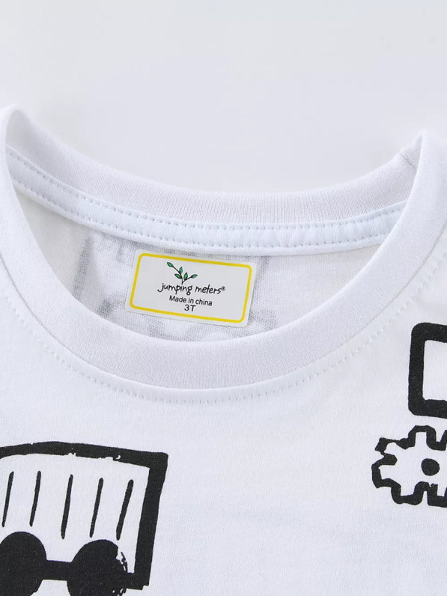 White cotton t-shirt with black construction vehicle graphic print and tag detail.