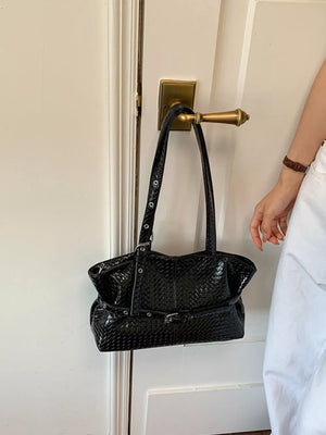 Black shoulder bag featuring woven texture and woven