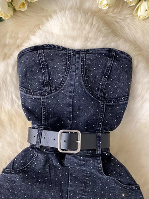 Black denim romper with rhinestone embellishments and a black belt.