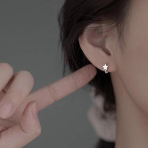 earrings in silver featuring star motif and hoop fit