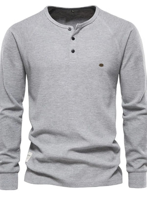 Gray waffle knit henley top with raglan sleeves and button placket.