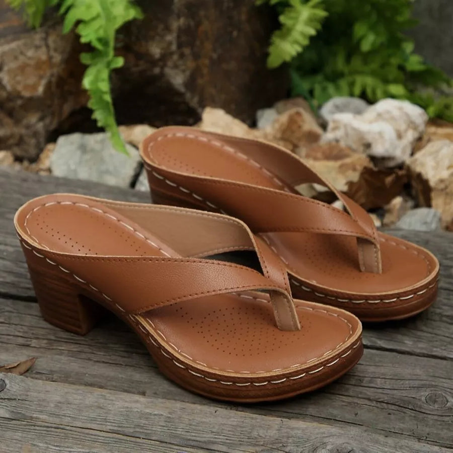 Tan leather toe-post block heel sandals with white stitching detail.