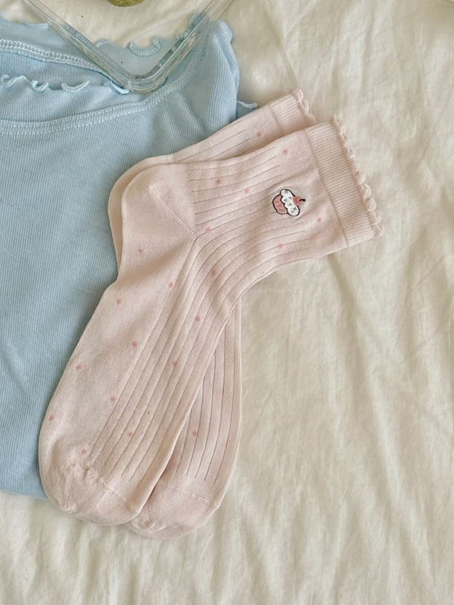 light pink socks featuring ribbed knit and polka dot