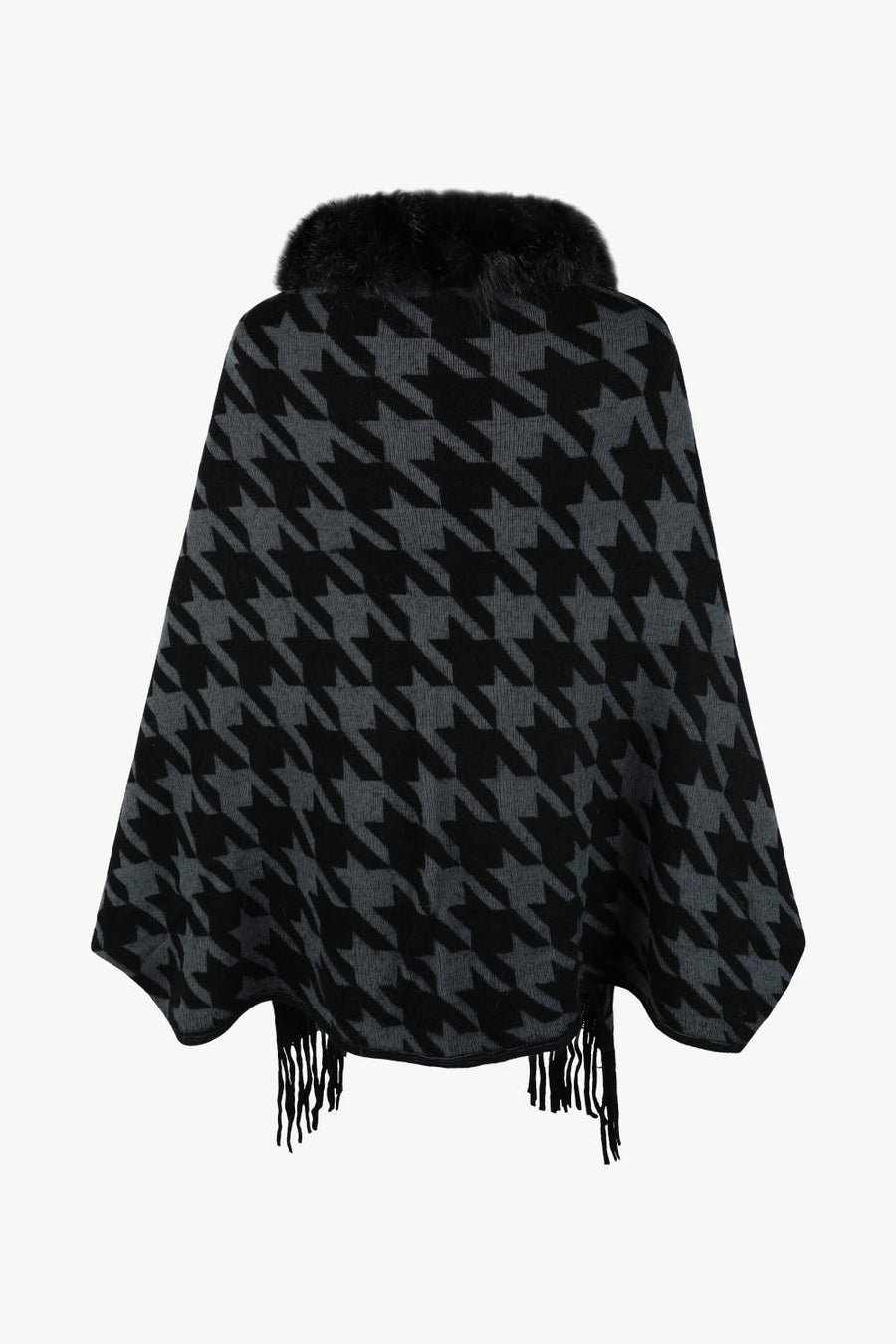 Houndstooth poncho with faux fur collar and fringe detail in black and grey.
