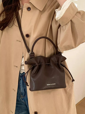 Brown pu leather cinch-top crossbody bag with knotted handle detail