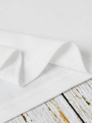 White t-shirt detail showing hem stitching and fabric texture