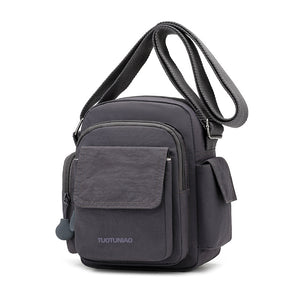 Gray lightweight nylon crossbody bag with multiple pockets and adjustable strap.