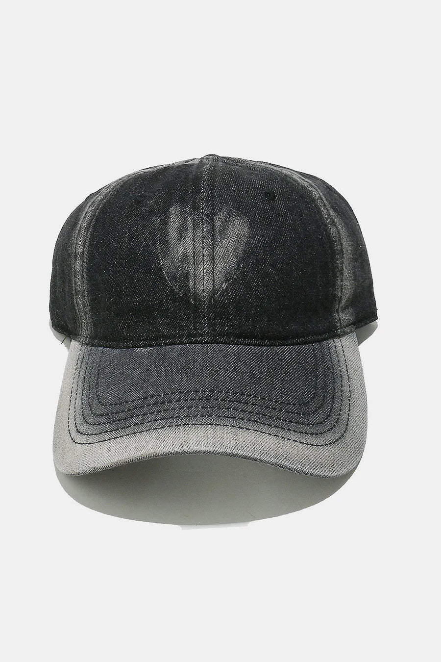 Bleached heart black baseball cap with a faded denim look.