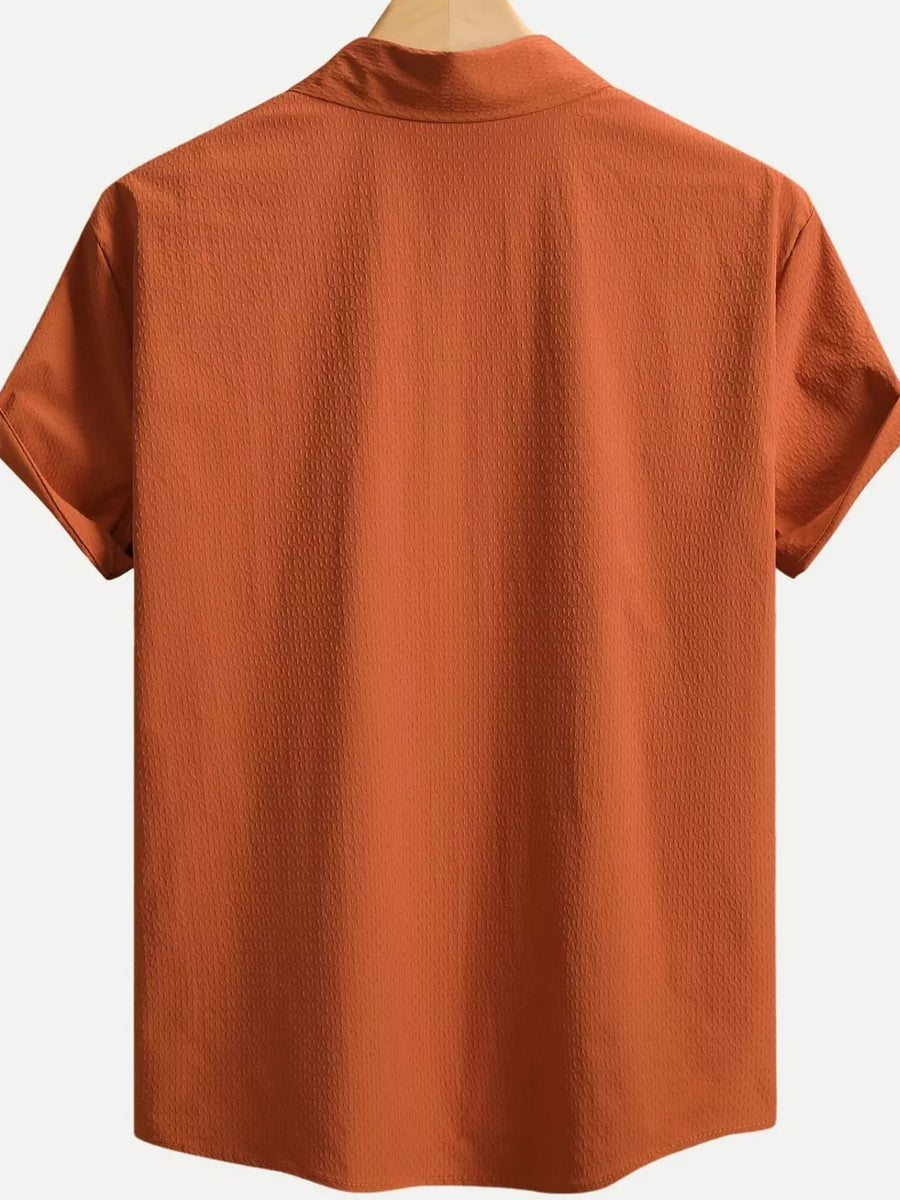 Orange textured cotton Cuban collar casual shirt with short sleeves.