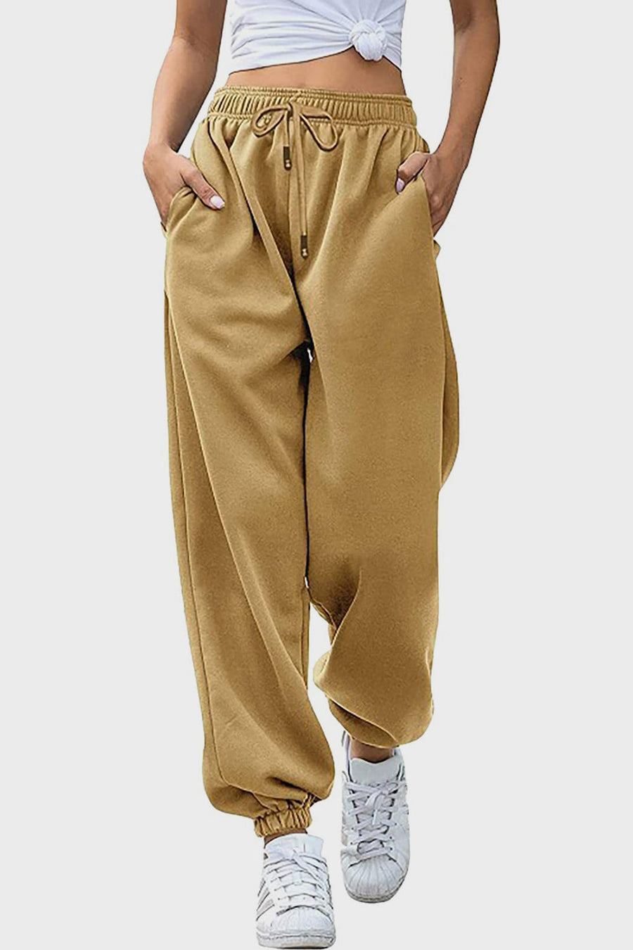 Slouchy sweatpants in tan with gathered cuffs and drawstring waist.