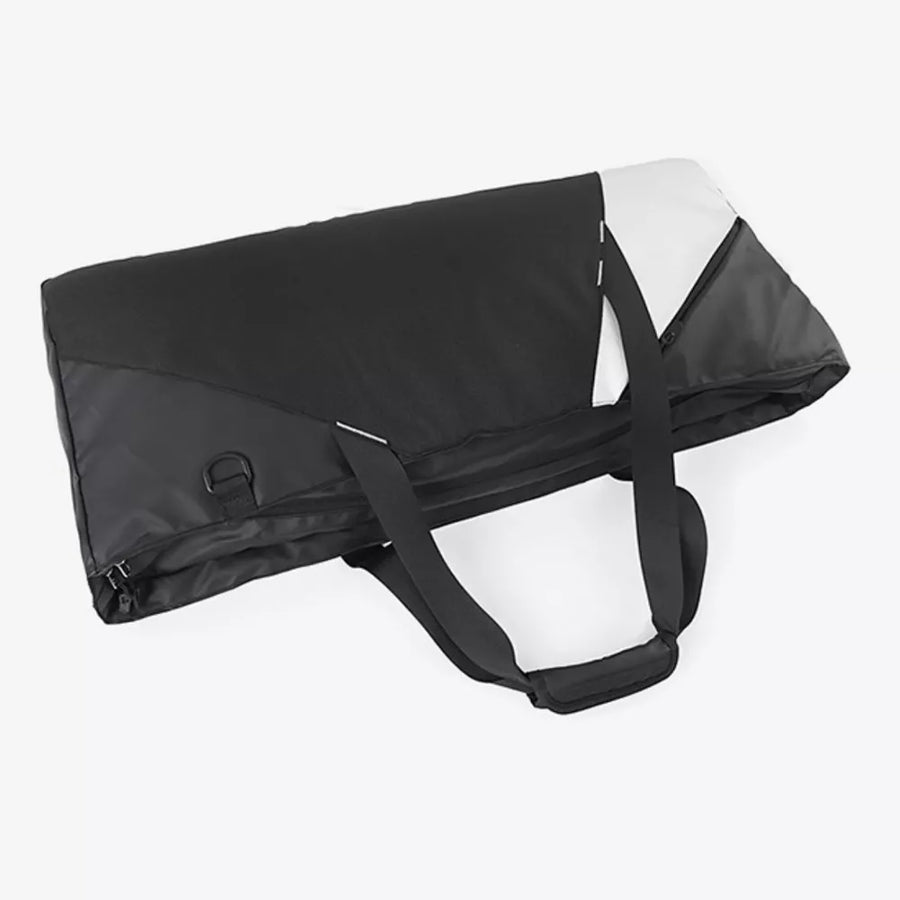 Modern color block travel bag in black with white accents and dual handles.