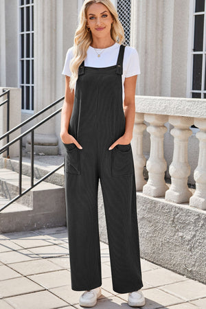 Striped denim overalls in dark gray with patch pockets and wide legs.