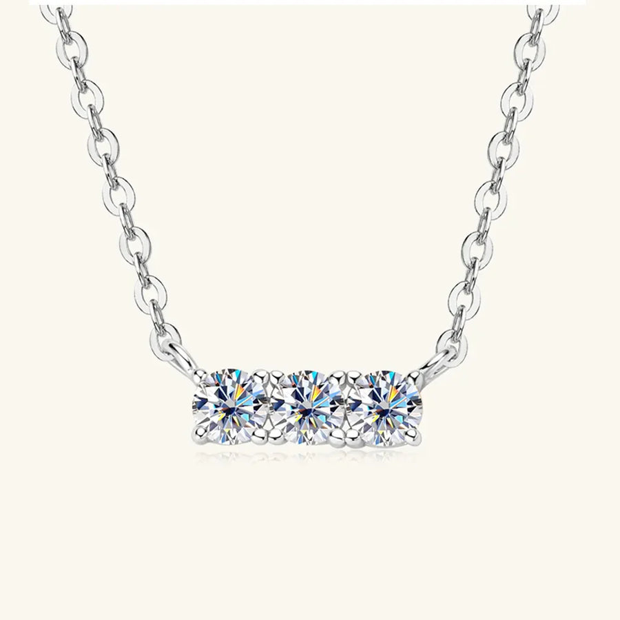 Silver bar necklace with three round moissanite stones on a delicate chain.
