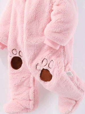 Pink fleece baby snowsuit with bear paw details on feet.