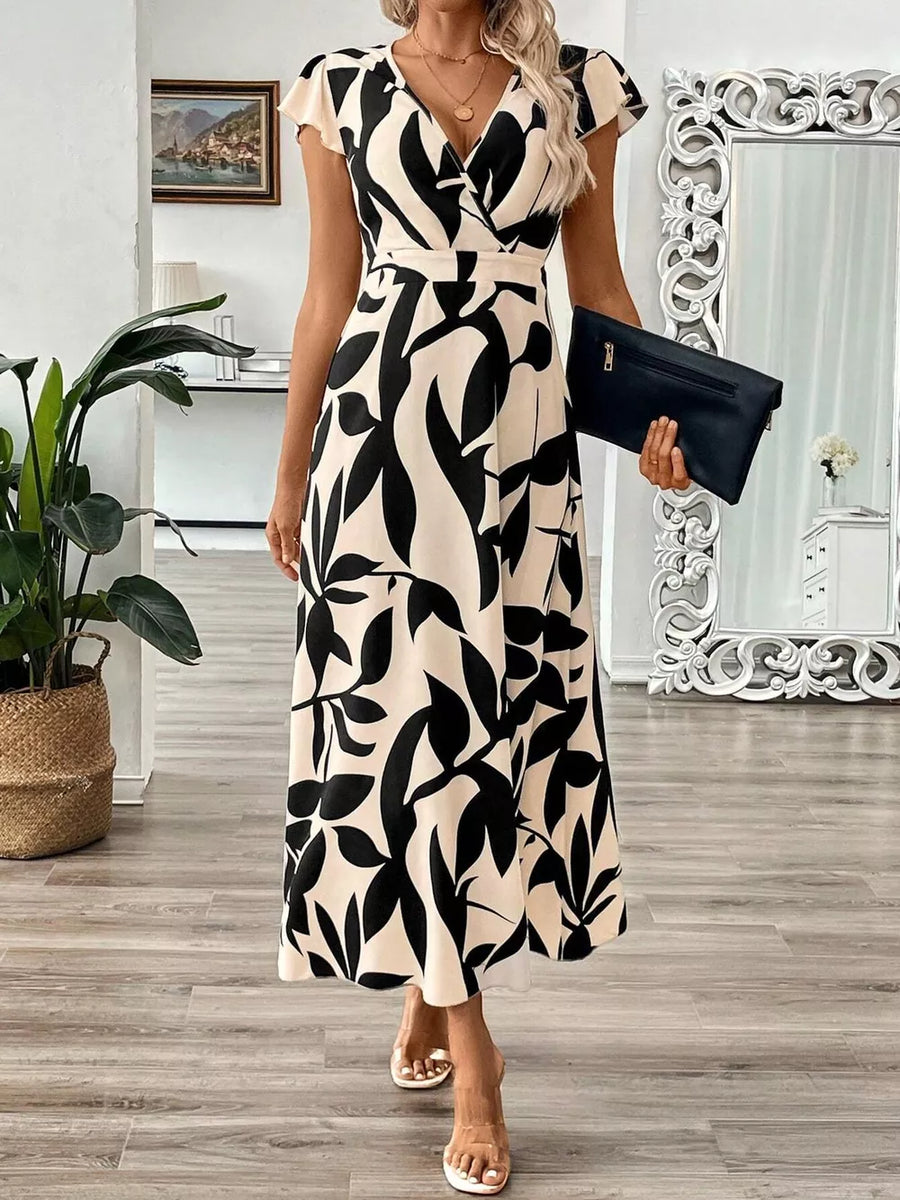 Floral print midi dress with cap sleeves and a V-neck in black and apricot abstract pattern.