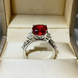 Sterling silver ring with large red cushion cut moissanite and baguette side stones.