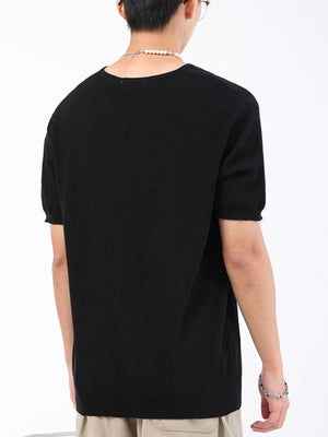 Black knit t-shirt with short sleeves and a crew neck.