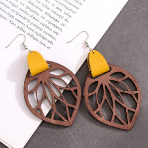 Leaf cutout wood dangle earrings with yellow leather accent
