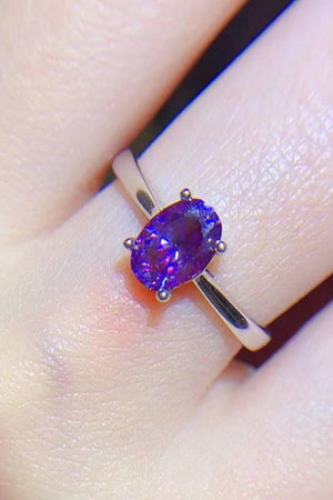 Oval cut amethyst solitaire ring with silver band
