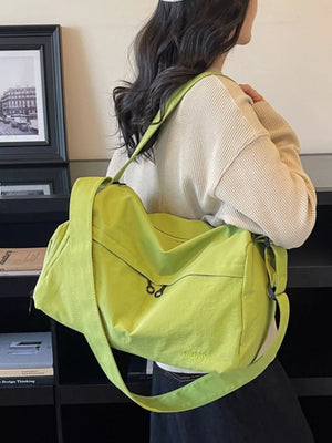 Lime green duffel bag with adjustable strap and zippered pockets, logo detail.