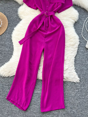 Rose red belted wide leg romper with button-down detail and gold buckle.