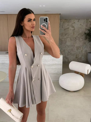 Gray double-breasted mini dress with V-neck, gold buttons, and pleated skirt.
